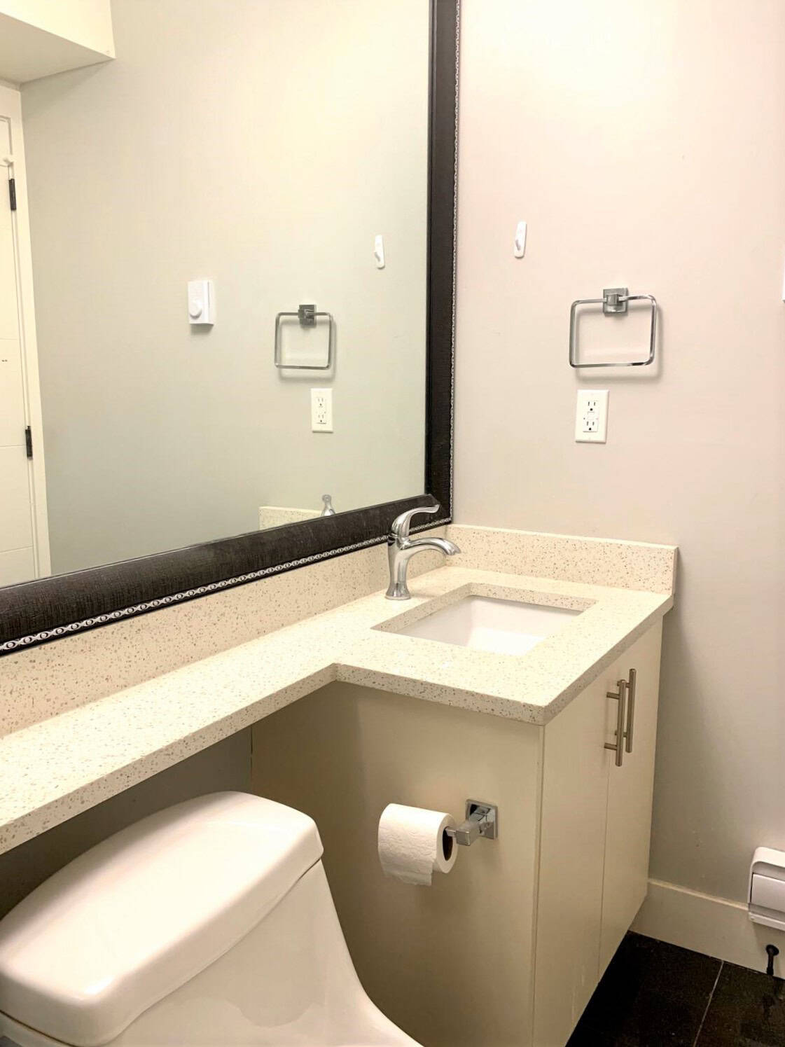 11 Modern Vancouver Island condo bathroom with neutral tones, granite countertop, and contemporary fixtures, showcasing comfortable and stylish living space near Orca Realty Inc.