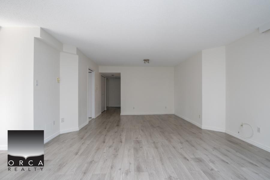 Bright modern living room with light wood flooring and neutral white walls, ideal for easy styling and furniture placement, perfect for Vancouver area real estate.