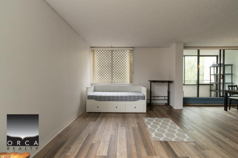 Bright modern apartment interior with large windows, hardwood flooring, and minimal decor, ideal for apartment rentals or real estate listings in Vancouver.