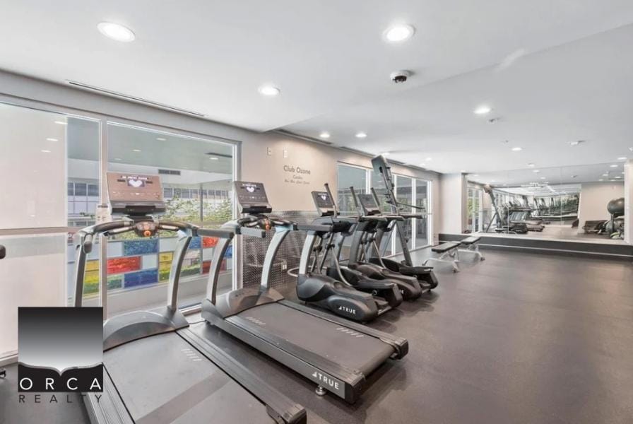 State-of-the-art fitness centre at Orca Realty Inc. with cardio equipment and gym facilities for residents.