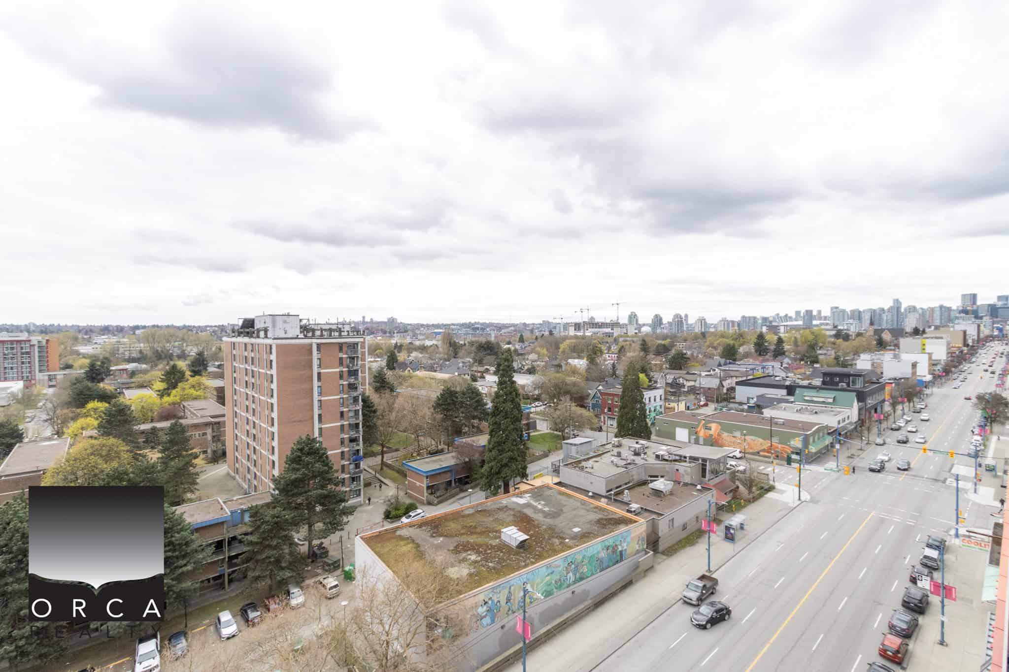 Vibrant cityscape view from a high-rise in Vancouver showcasing urban living, diverse local businesses, and green spaces, ideal for real estate investments and residential opportunities in downtown Vancouver.