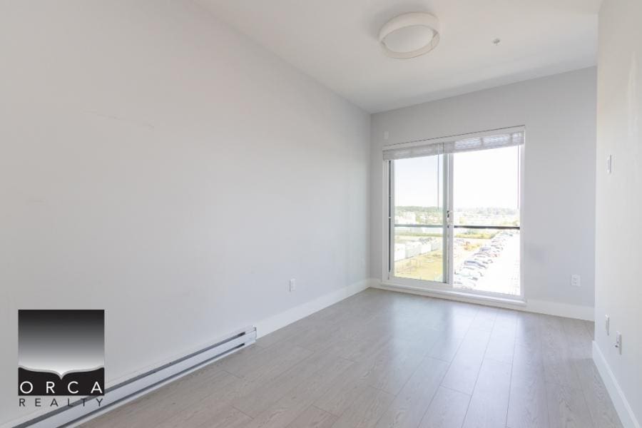 Bright modern apartment with large window and city views, ideal for Vancouver real estate buyers seeking contemporary condos in desirable locations.