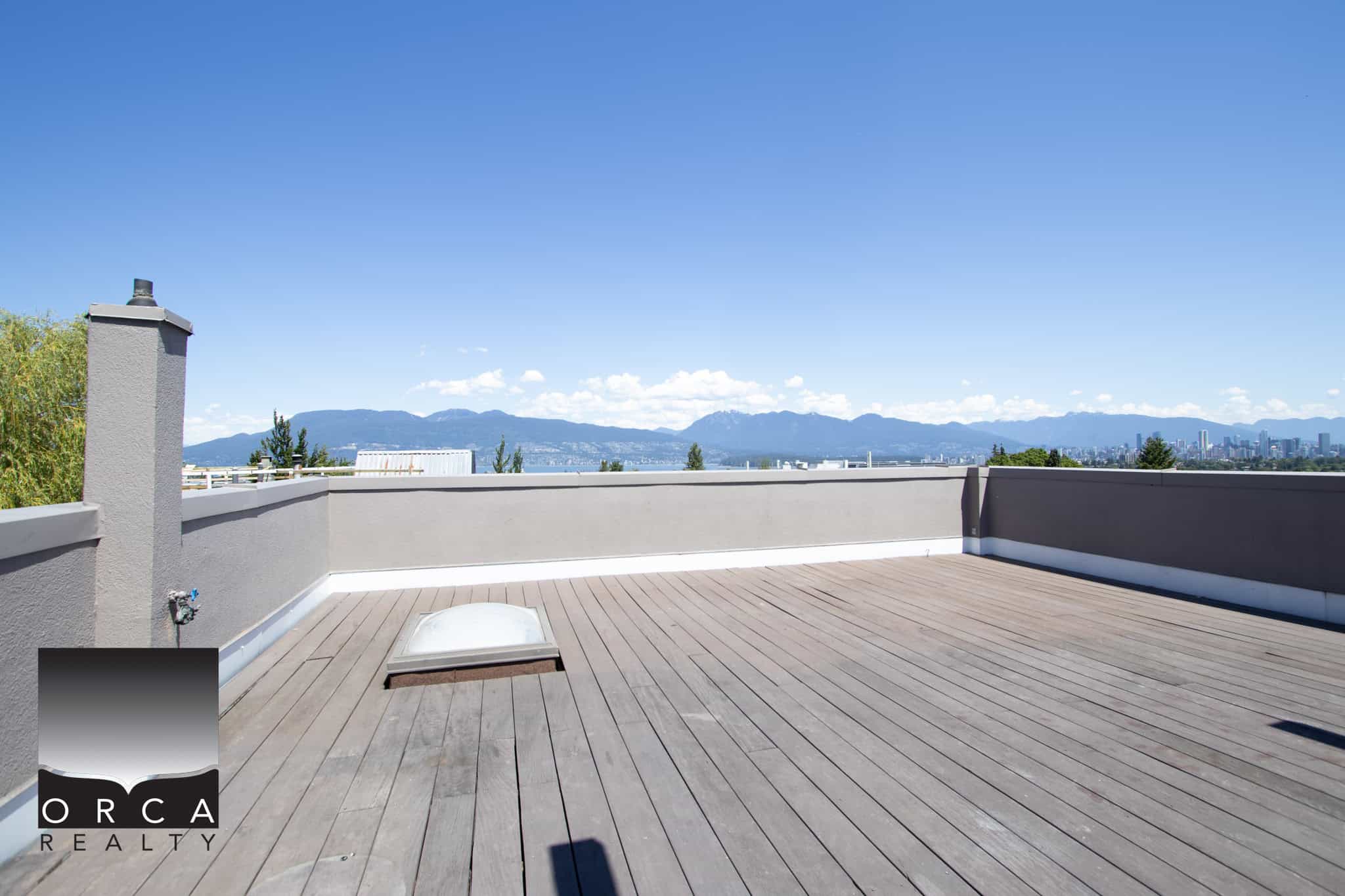 Stunning rooftop terrace with panoramic city and mountain views, perfect for outdoor living and entertaining in Vancouver.