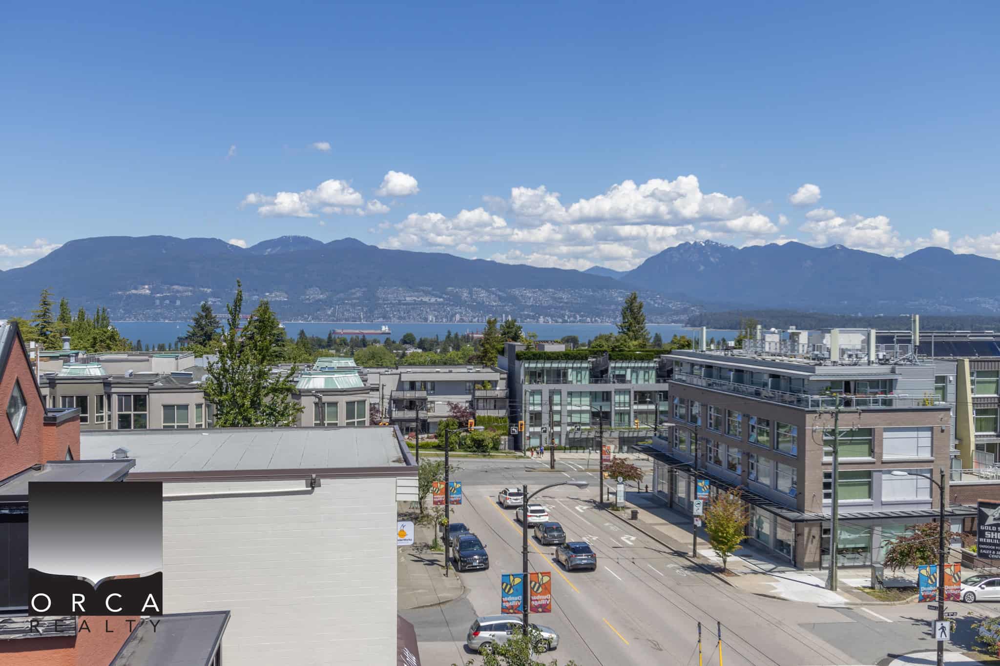Vibrant cityscape view with modern buildings and mountain backdrop, showcasing potential Vancouver area real estate.