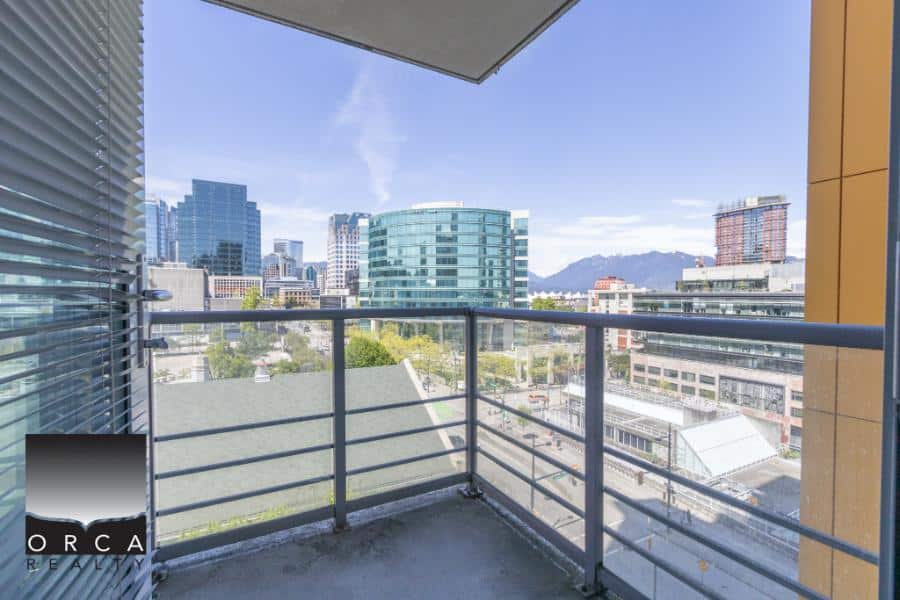 Modern city skyline view from a high-rise balcony in downtown Vancouver, BC.