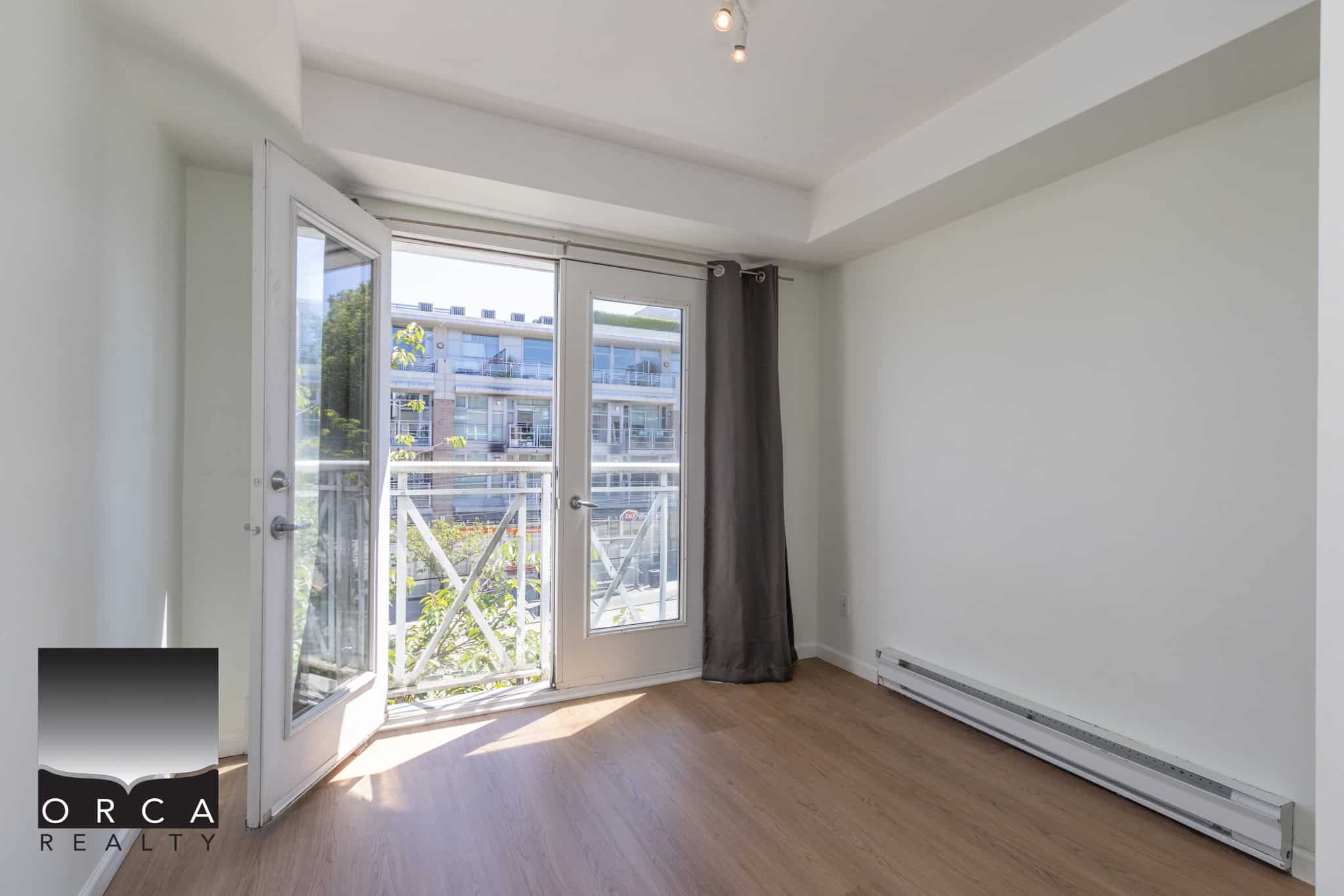 Bright rental apartment with balcony in an urban Vancouver neighbourhood, featuring large windows, hardwood floors, and modern amenities perfect for comfortable city living.