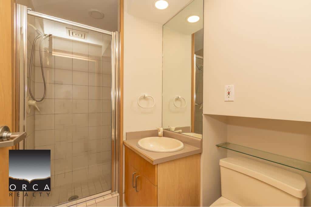 Shower bathroom at Orca Realty property, modern clean bathroom with shower and vanity, ideal for Vancouver real estate listings.