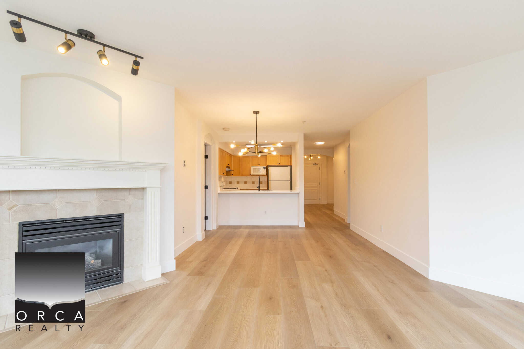Bright open-concept living room and kitchen with modern finishes, hardwood flooring, and natural light, ideal for Vancouver Island real estate buyers.