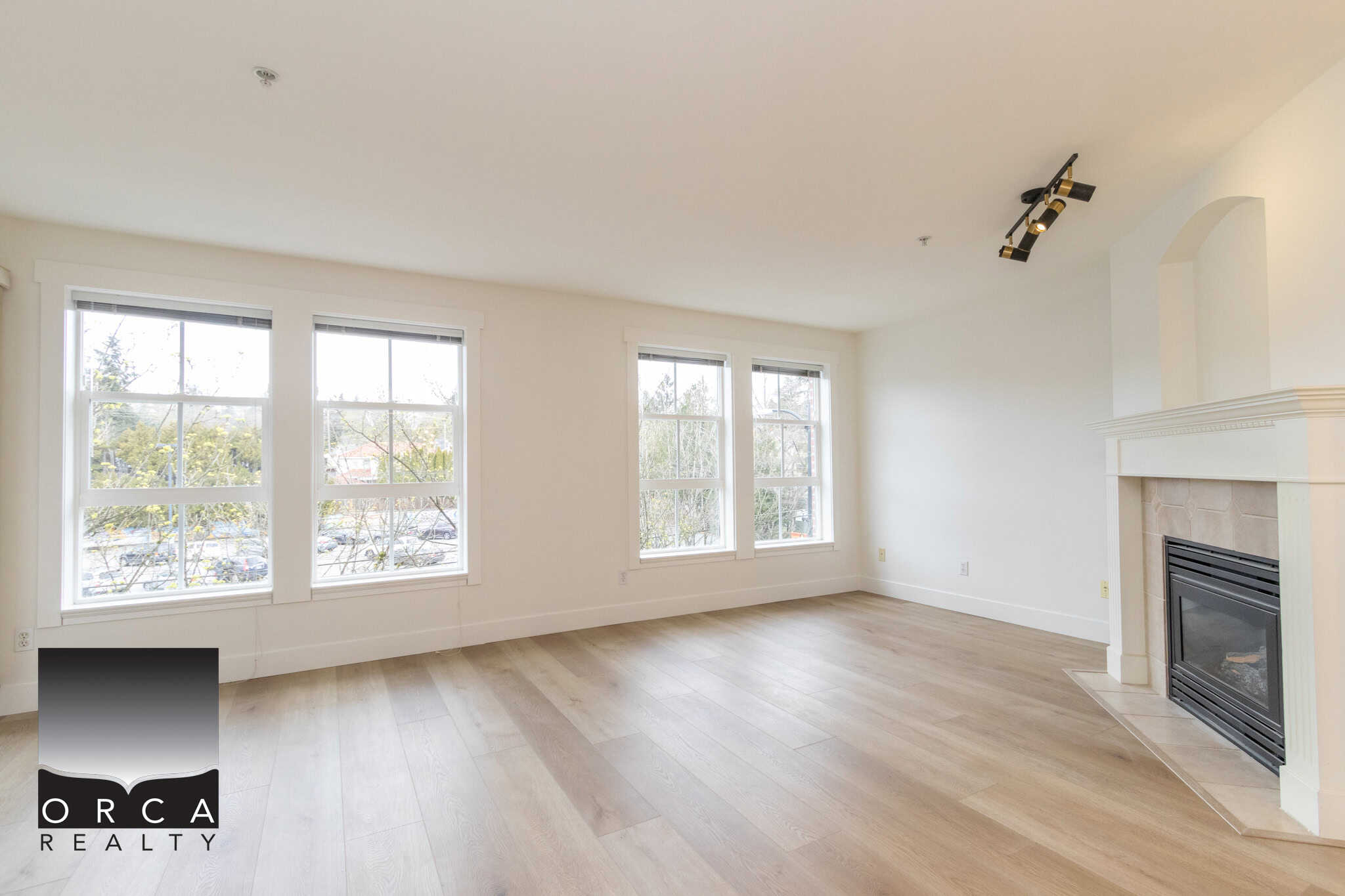 Bright living room with large windows, natural light, and modern features, ideal for Vancouver Real Estate listings and home buyers seeking spacious, updated interiors in BC.