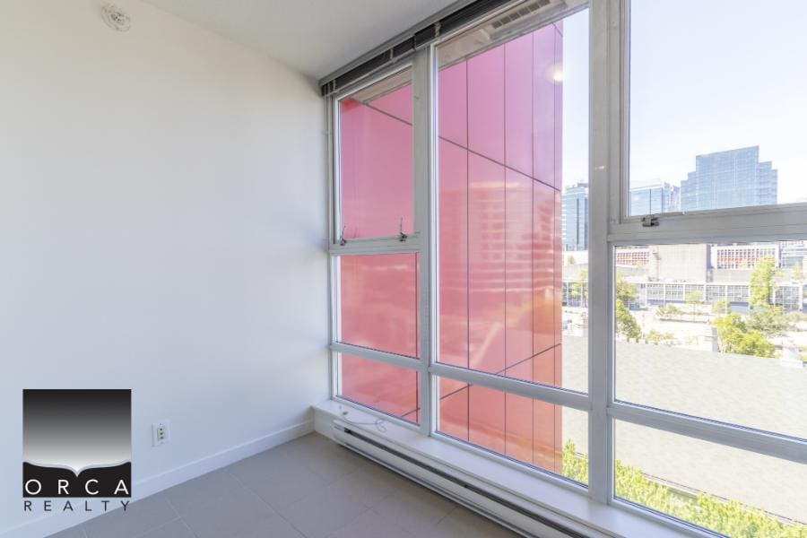 Modern urban condominium interior with large windows and city views, perfect for Vancouver real estate investors and buyers seeking downtown apartments.