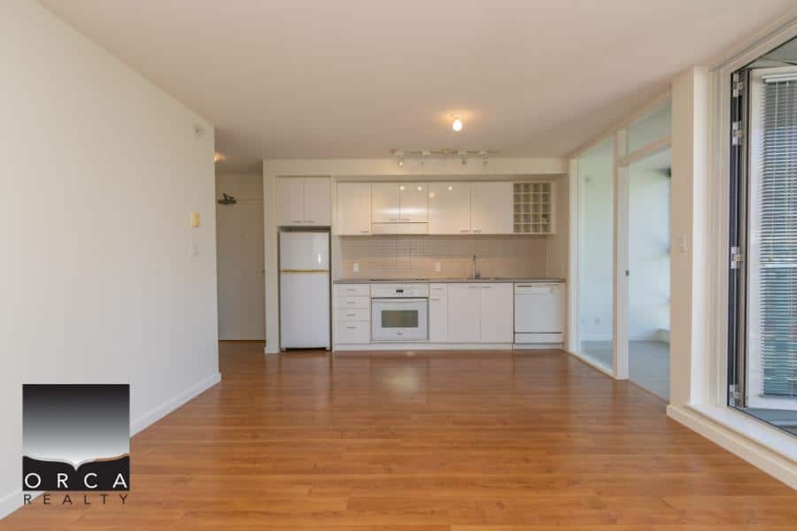 Modern kitchen and living space in a Vancouver-area apartment listing by Orca Realty Inc.