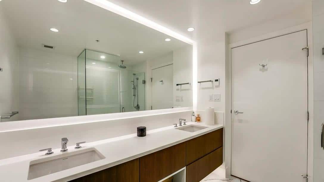 Luxurious modern bathroom with double sinks, sleek design, and glass shower enclosure—perfect for upscale Vancouver Island real estate.
