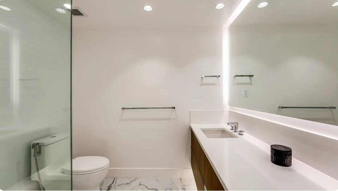 Bright modern bathroom with sleek white walls and contemporary fixtures, perfect for Vancouver real estate listings and property sales.