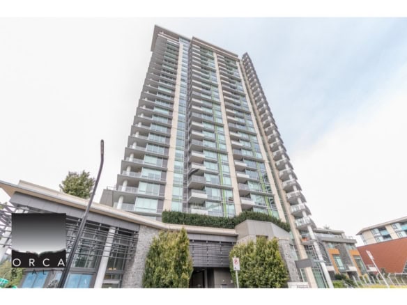 Modern high-rise condominium building in Vancouver featuring glass balconies, sleek architectural design, and surrounding greenery, ideal for Toronto or Vancouver real estate investment.