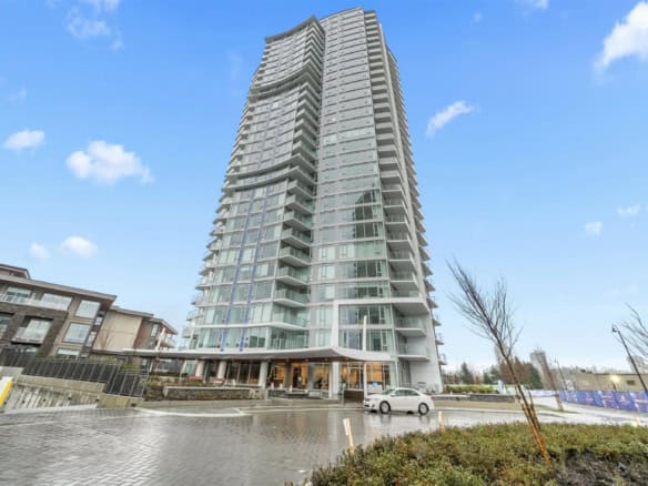 Contemporary high-rise condo building in Vancouver with glass exterior and spacious balconies, representing luxurious urban living options in BC.