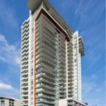Modern high-rise condominium building in Vancouver with spacious balconies and contemporary architecture for luxury urban living.