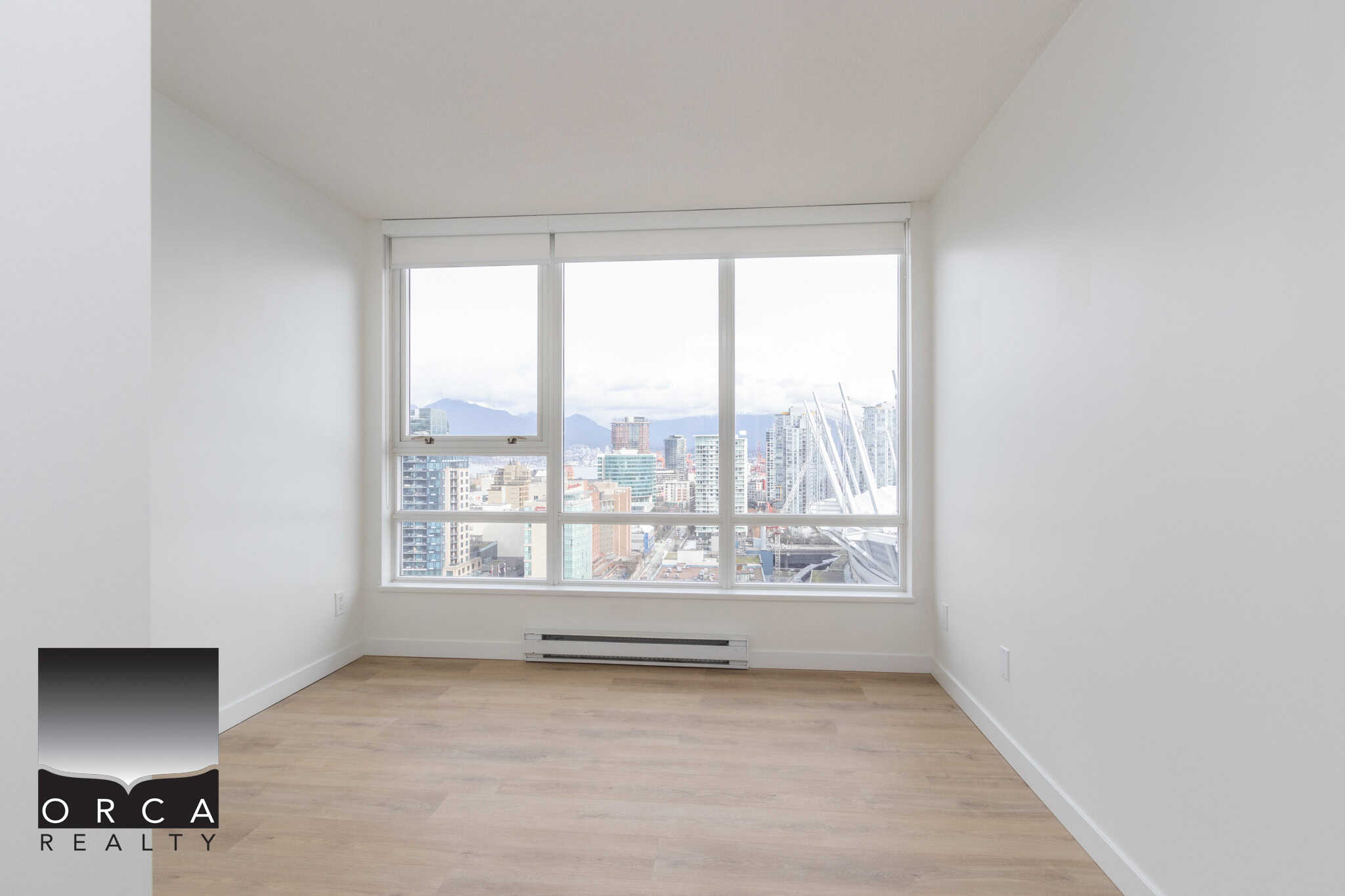 10 Stunning city view from modern high-rise apartment window in Vancouver, BC, showcasing Orca Realty Inc. expertise in Vancouver real estate.