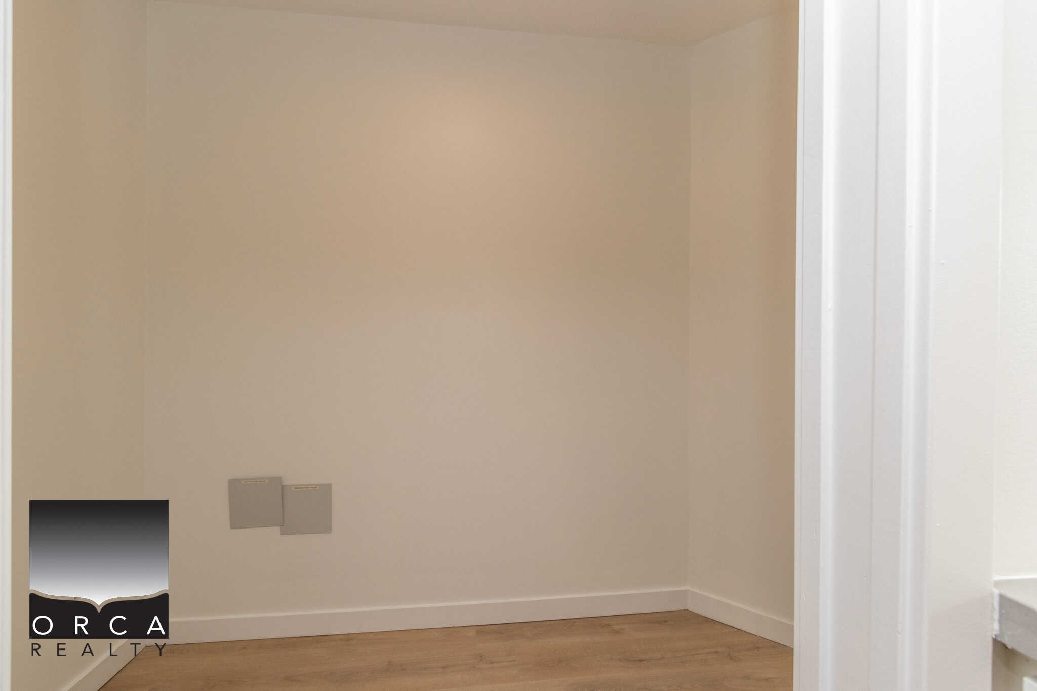 12 Bright, empty laundry or utility room with white walls and light wooden flooring, ideal for residential property in Vancouver or the surrounding areas.