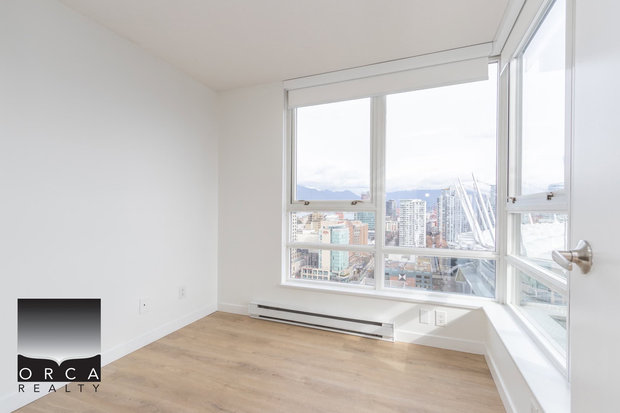 16 Stunning city view from a modern high-rise apartment showcasing bright natural light and sleek interior design, ideal for Vancouver real estate buyers.