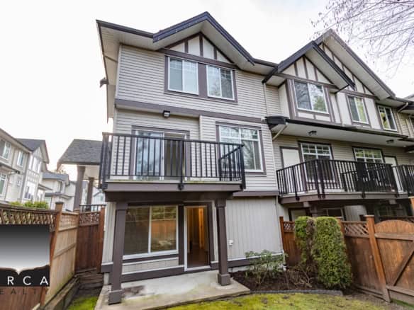 Modern multi-level townhome with private balconies and fenced backyard in a family-friendly neighbourhood near Orca Realty Inc.