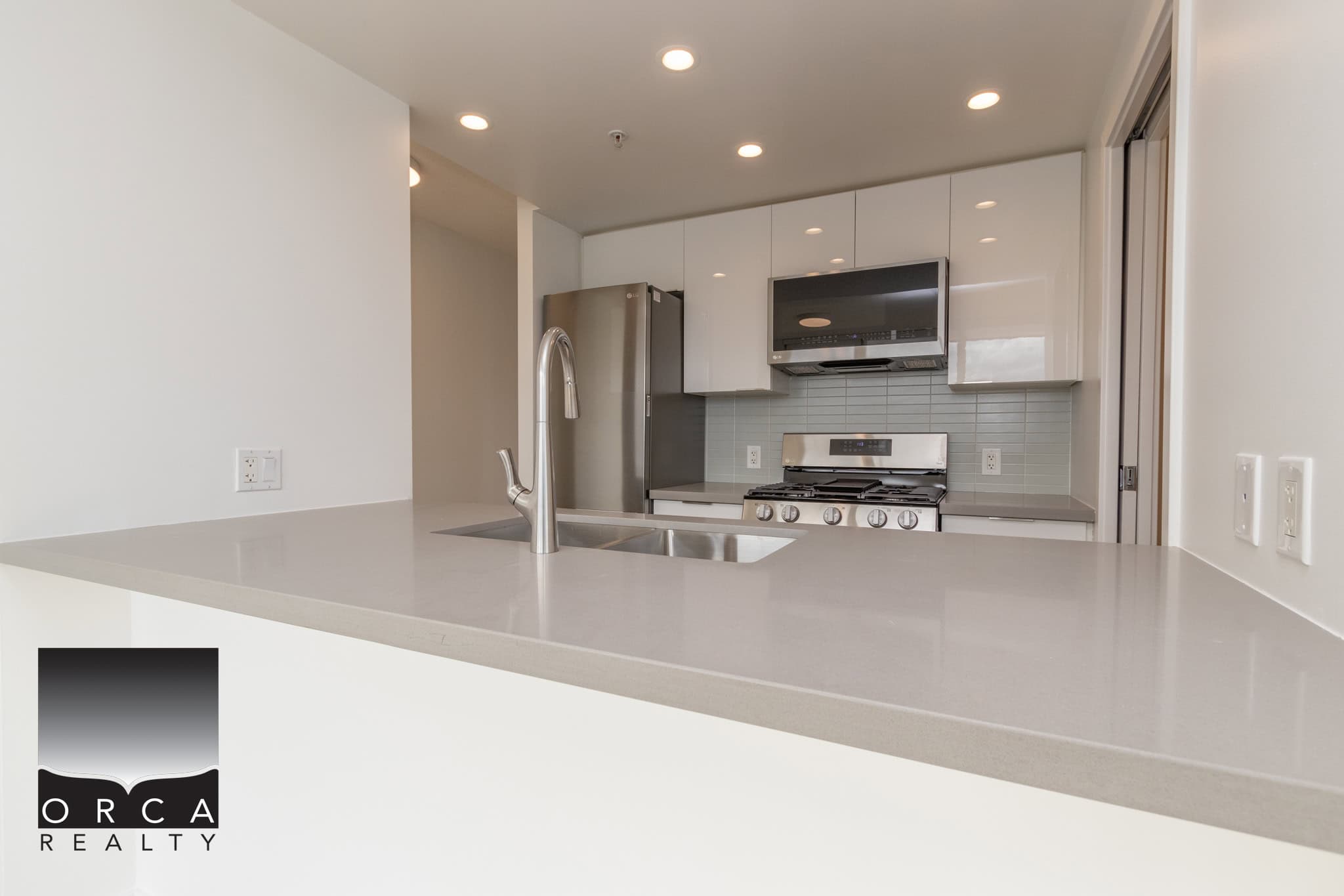 6 Modern kitchen with stainless steel appliances and minimalist white cabinetry, perfect for contemporary Vancouver Island homes.