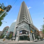 Luxurious high-rise condo building in downtown Vancouver, BC, showcasing modern architecture, retail space, and vibrant urban setting. Perfect for real estate investment or city living.