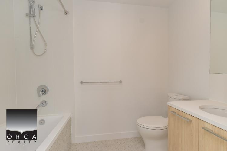 Modern bathroom with shower, bathtub, toilet, and vanity -- ideal for Vancouver or Victoria homes. Trust Orca Realty Inc. for expert real estate services in British Columbia.