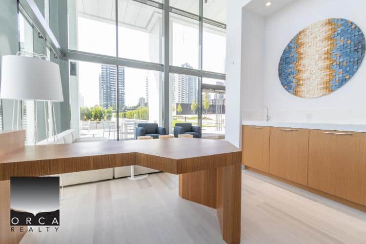 Modern office interior with sleek wooden furniture and panoramic city views, showcasing Orca Realty Inc.'s professional commercial property services in Vancouver.