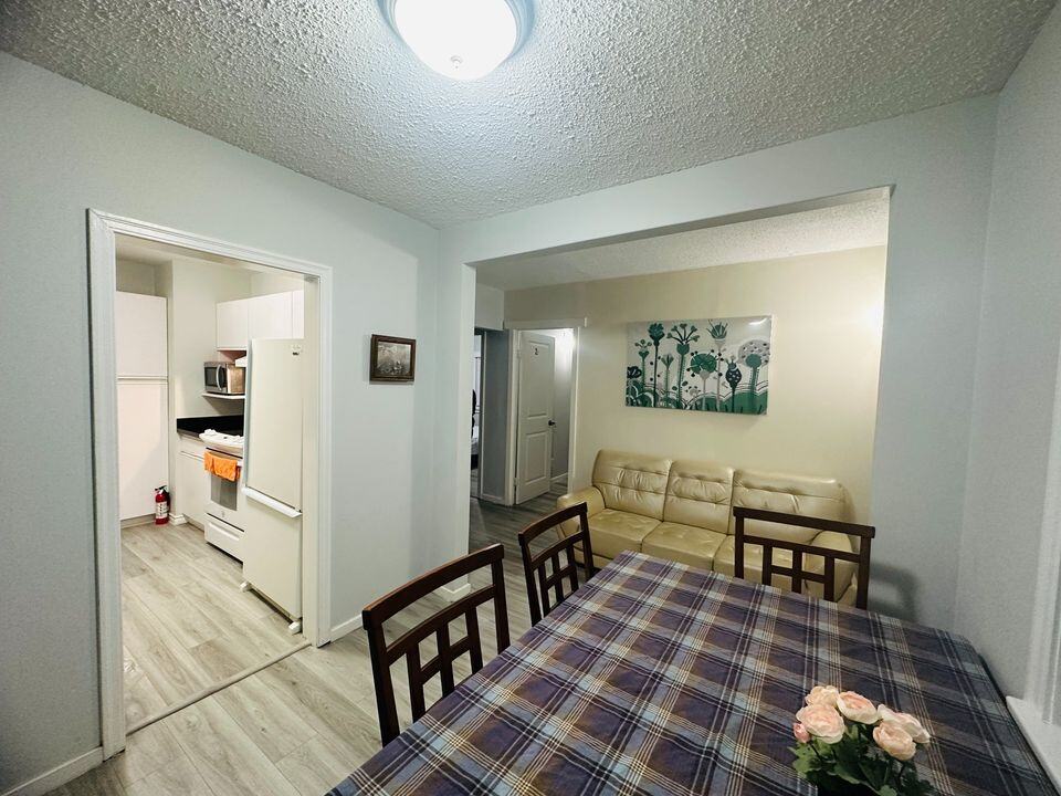 Bright and inviting interior view of a modern residential home, showcasing a cozy dining area, a comfortable living space, and a functional kitchen, perfect for family living and entertaining.