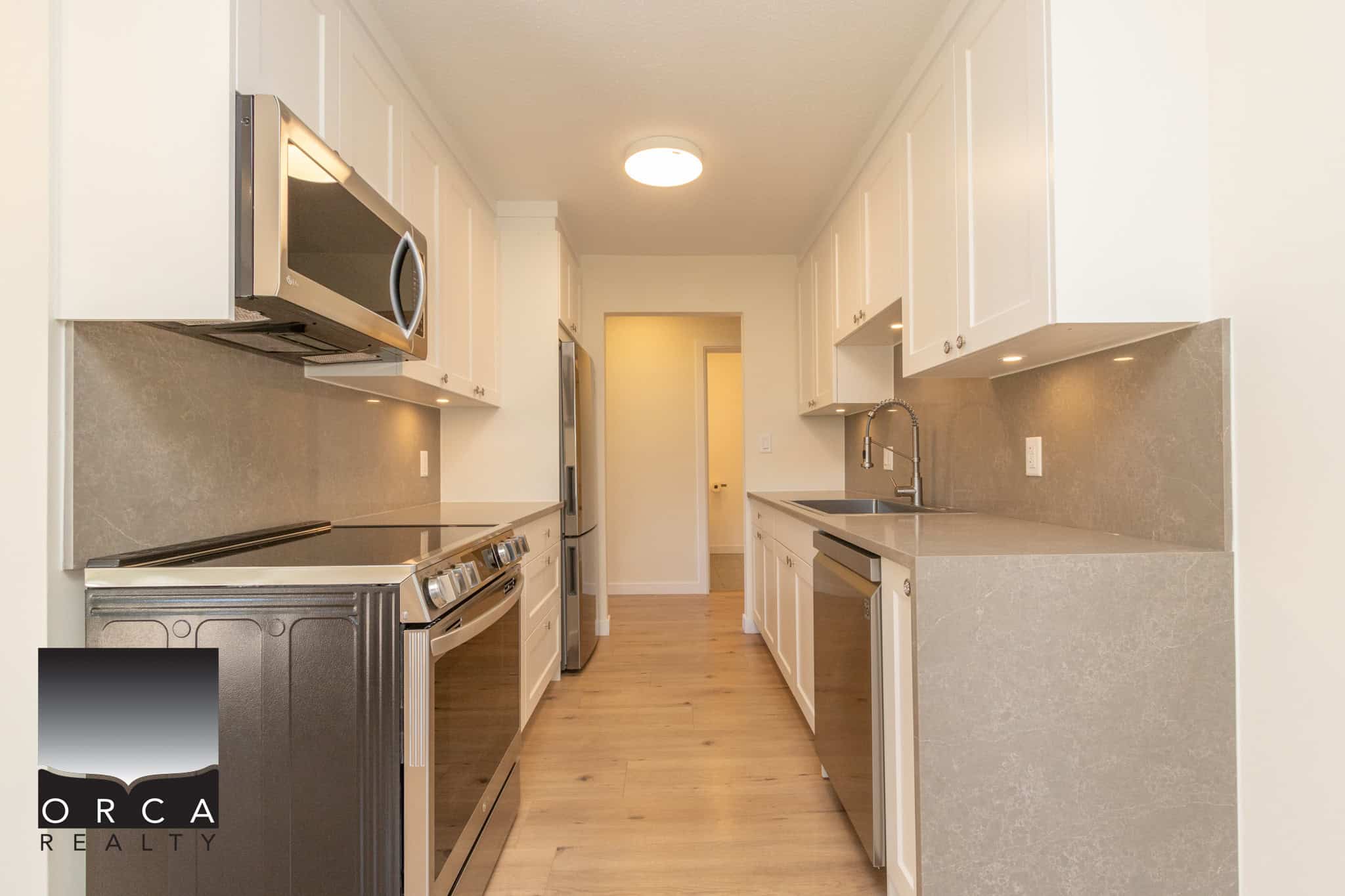 Modern stainless steel appliances in a sleek, updated kitchen at Orca Realty Inc., showcasing contemporary cabinetry and countertops perfect for Vancouver Island real estate.