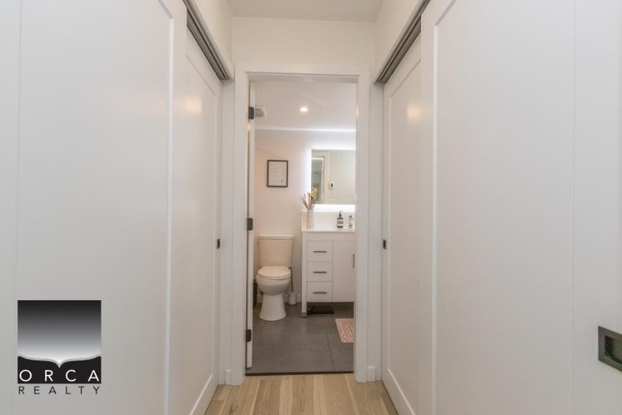 Bright bathroom with modern fixtures and white cabinetry in a stylish Calgary home, available through Orca Realty Inc., your trusted Calgary real estate expert.