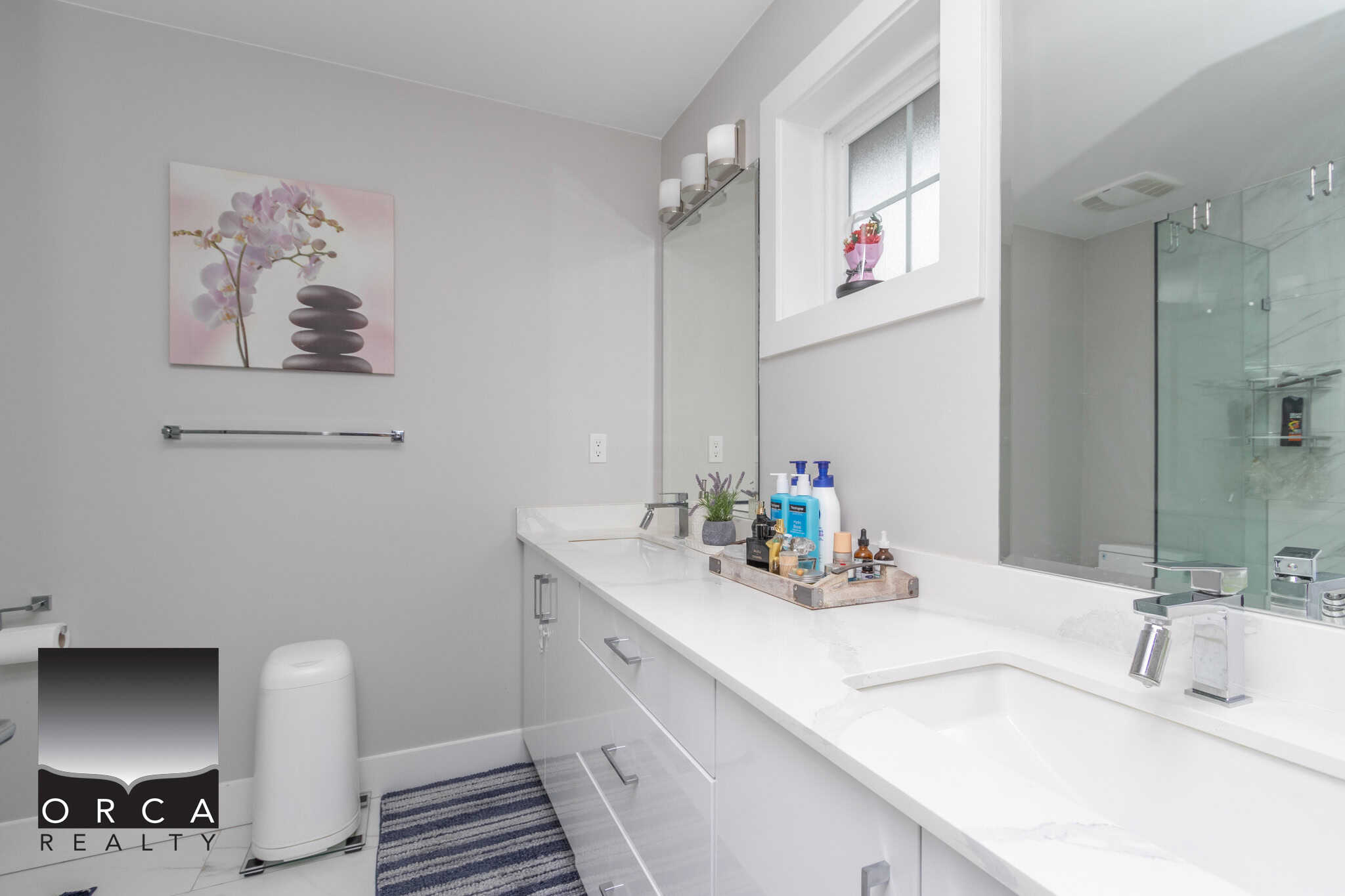18 Bright modern bathroom interior showcasing sleek white cabinetry, stylish decor, and a spacious vanity area with natural light, ideal for Vancouver real estate listings.