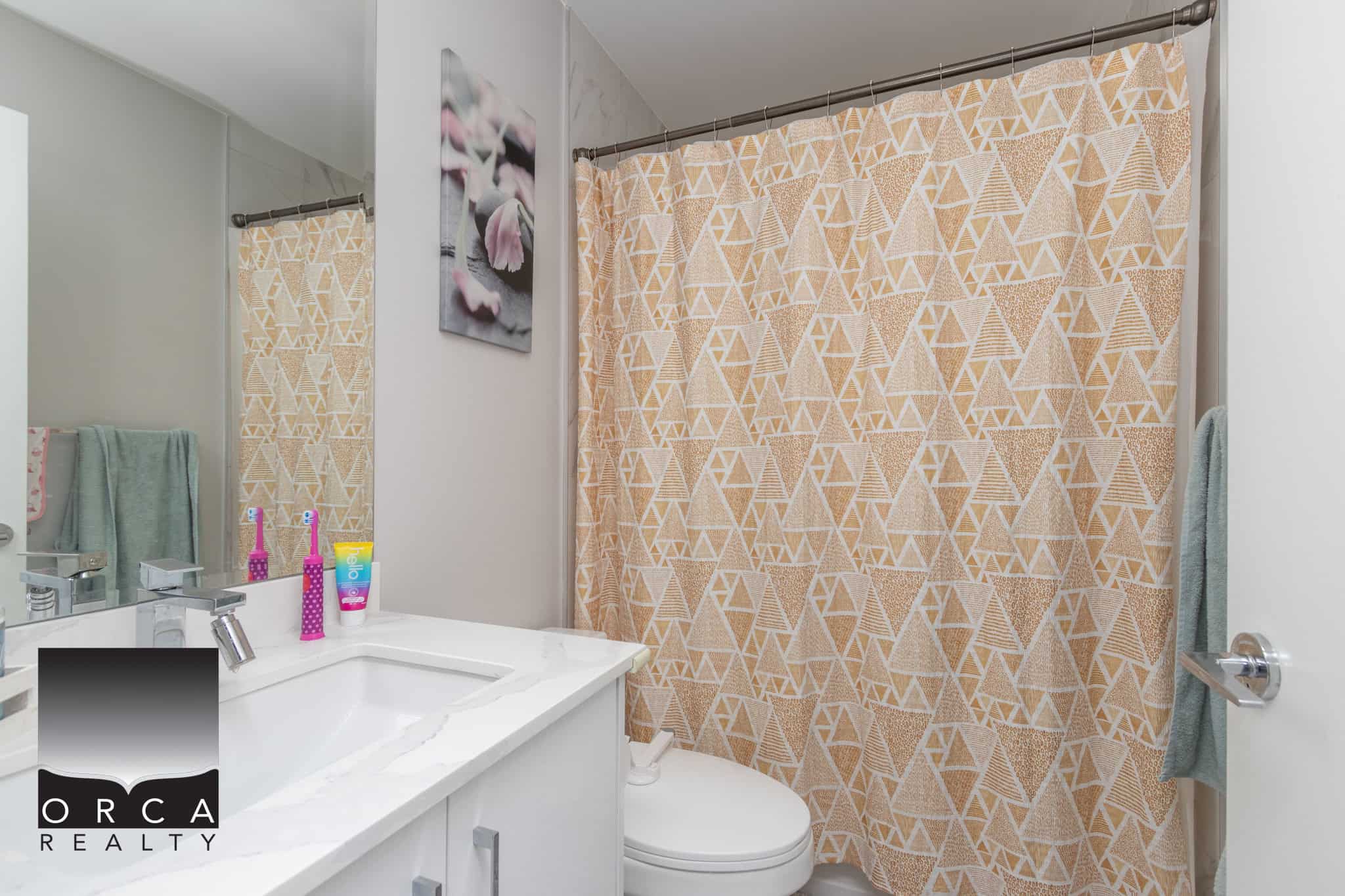 21 Bright bathroom with beige geometric shower curtain, white vanity and modern fixtures, ideal for Vancouver real estate listings.