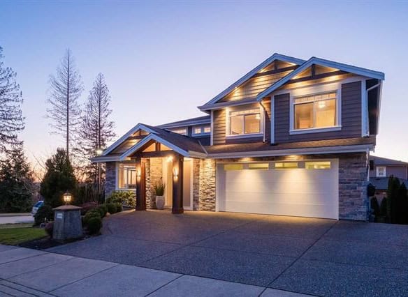 Modern two-storey family home with contemporary design and beautiful exterior lighting in a peaceful neighbourhood in BC.