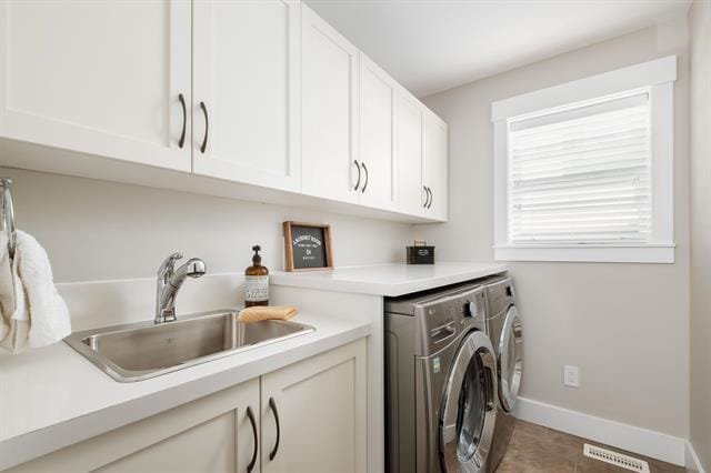 Modern laundry room with white cabinetry and stainless steel washer and dryer, featuring a bright window and minimalist design, perfect for convenient home cleaning and organization.