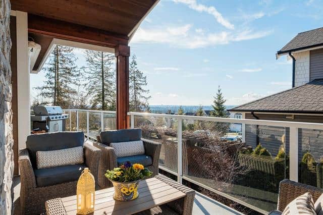 Modern balcony with outdoor seating, view of trees and water, perfect for real estate listings, homes with outdoor living spaces, and property listings in Ontario.
