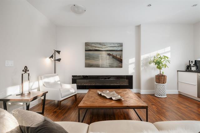Modern living room interior with minimalist design, white walls, hardwood flooring, and contemporary decor, ideal for Vancouver real estate listings and home staging by Orca Realty Inc.