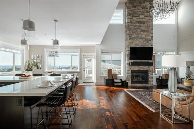 Luxurious open-concept living and dining area with modern decor, large windows, and a fireplace, perfect for Vancouver real estate showcasing elegant homes for sale in BC.