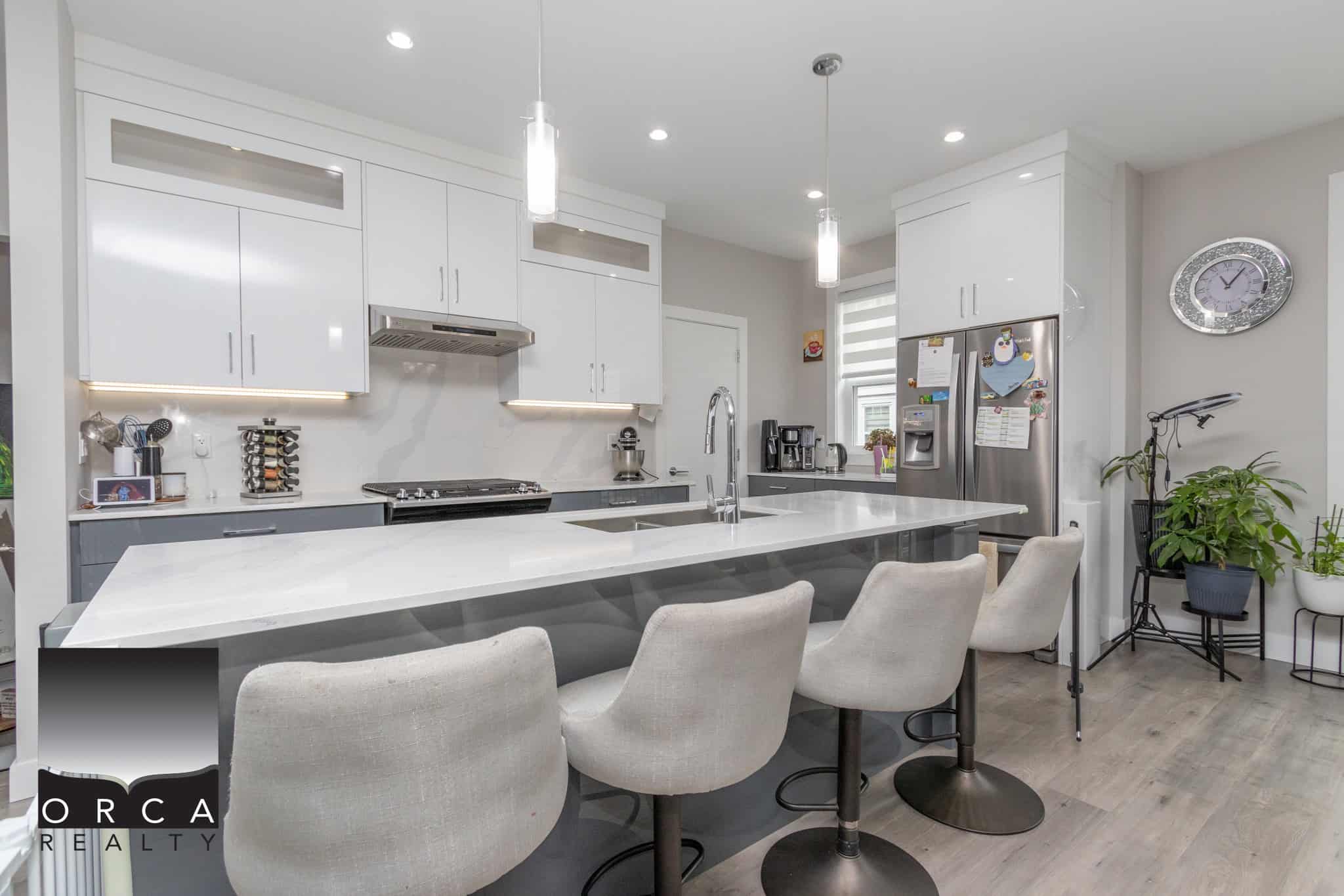 5 Modern kitchen with white and grey cabinetry, sleek appliances, and a spacious island, perfect for homebuyers seeking stylish Vancouver Island homes.
