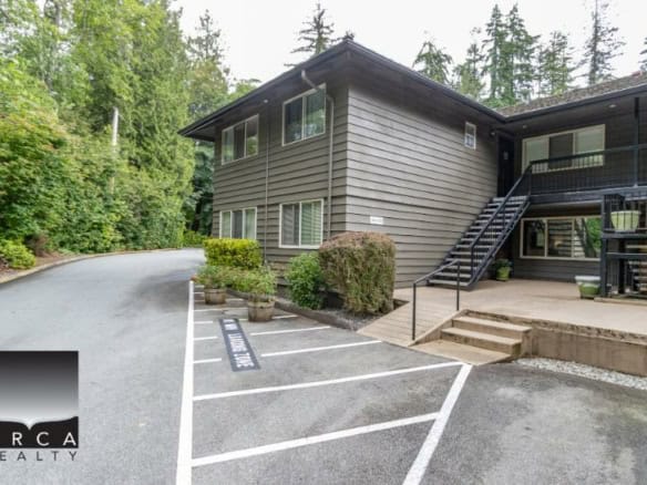 Spacious residential building with modern exterior design, surrounded by lush greenery in a serene Vancouver area. Perfect for families seeking comfortable and stylish living in British Columbia.