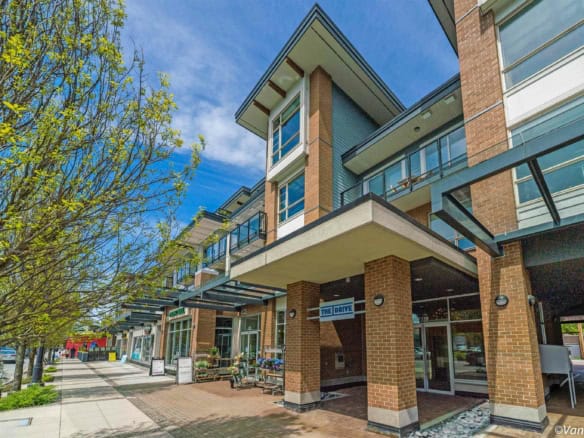 Modern multi-level commercial building with retail shops, situated on a vibrant downtown street, featuring brick and glass facades, outdoor seating, and lush greenery, ideal for real estate investment.