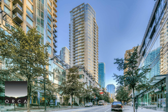 Modern Vancouver downtown high-rise buildings with retail shops and trees, representing prime real estate and commercial property services by Orca Realty Inc.