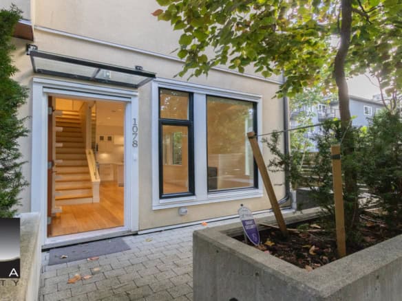 Modern Vancouver Westtown house entrance with large windows, wooden staircase, and landscaped front yard, showcasing Orca Realty's innovative real estate listings in BC.