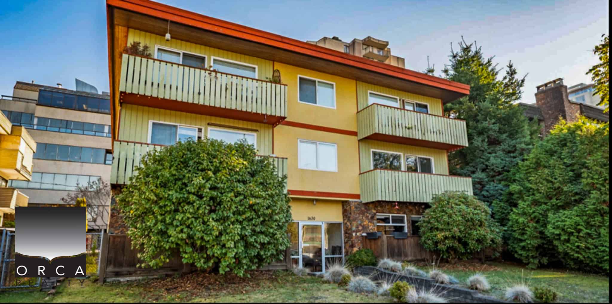 Modern multi-unit apartment building with vibrant yellow exterior and green balconies in a lush upright urban setting, ideal for real estate investment and rental opportunities.