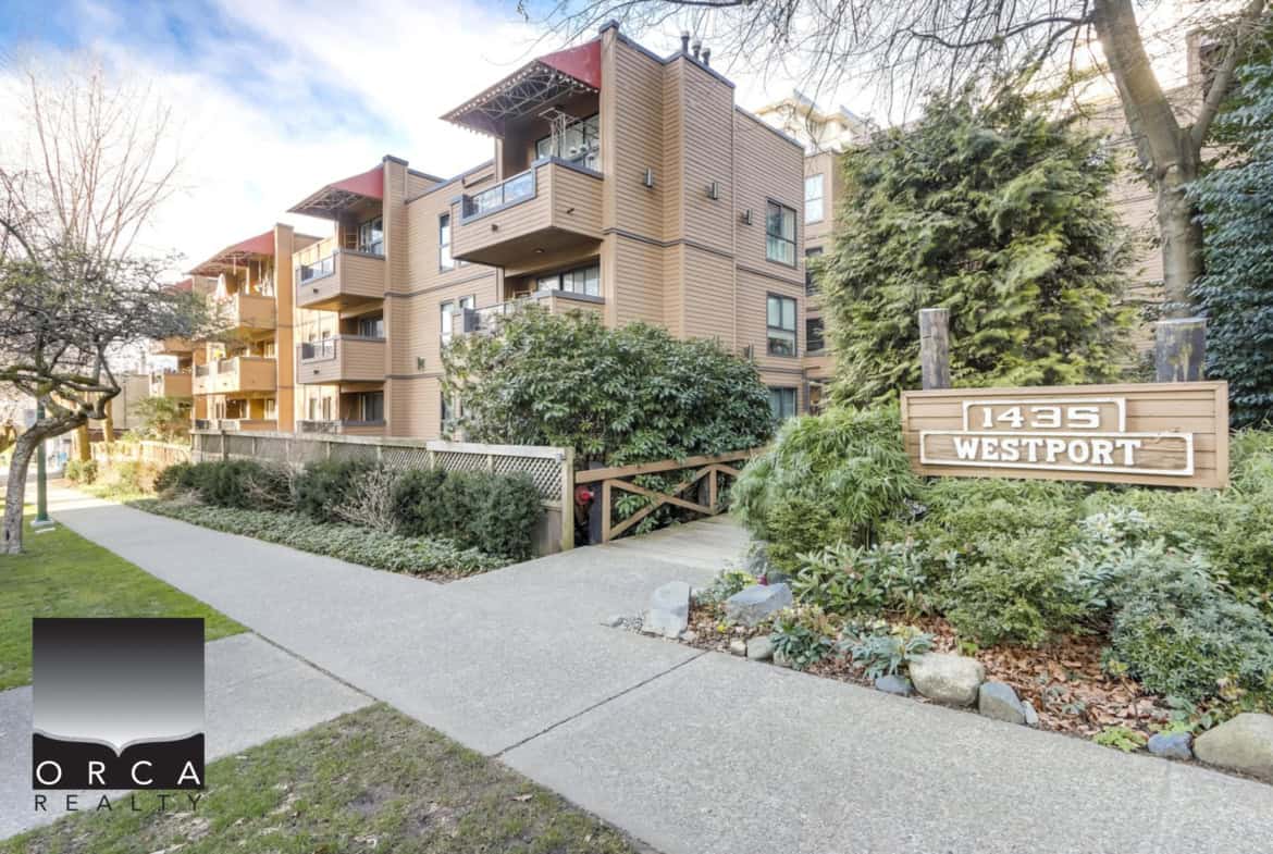 Modern urban residential building at 1435 Westport with lush landscaping and a welcoming pathway, representing Orca Realty Inc.'s expertise in Vancouver-area property sales and rentals.