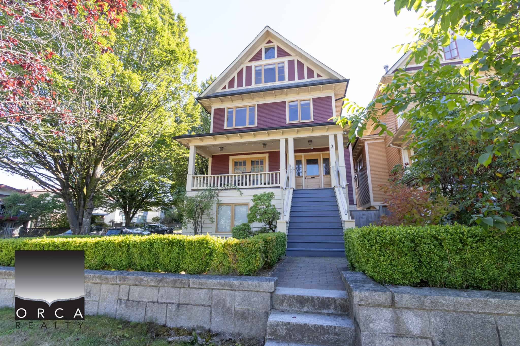 Charming Victorian-style house in Vancouver on Orca Realty’s real estate listings, featuring a welcoming porch, lush landscaping, and historic architecture, ideal for buyers seeking Vancouver homes.