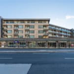 Modern mixed-use building with residential apartments and retail spaces in Vancouver's urban core. Features stylish balconies, large windows, and ground-floor shops, perfect for downtown urban living.