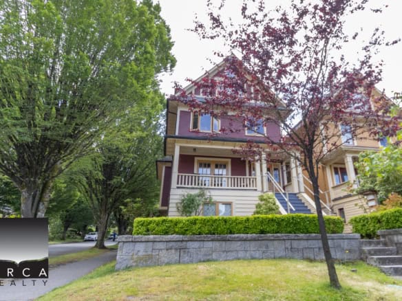 Charming multi-story house with vibrant exterior and lush landscaping, ideal for homebuyers seeking real estate in a peaceful neighbourhood.