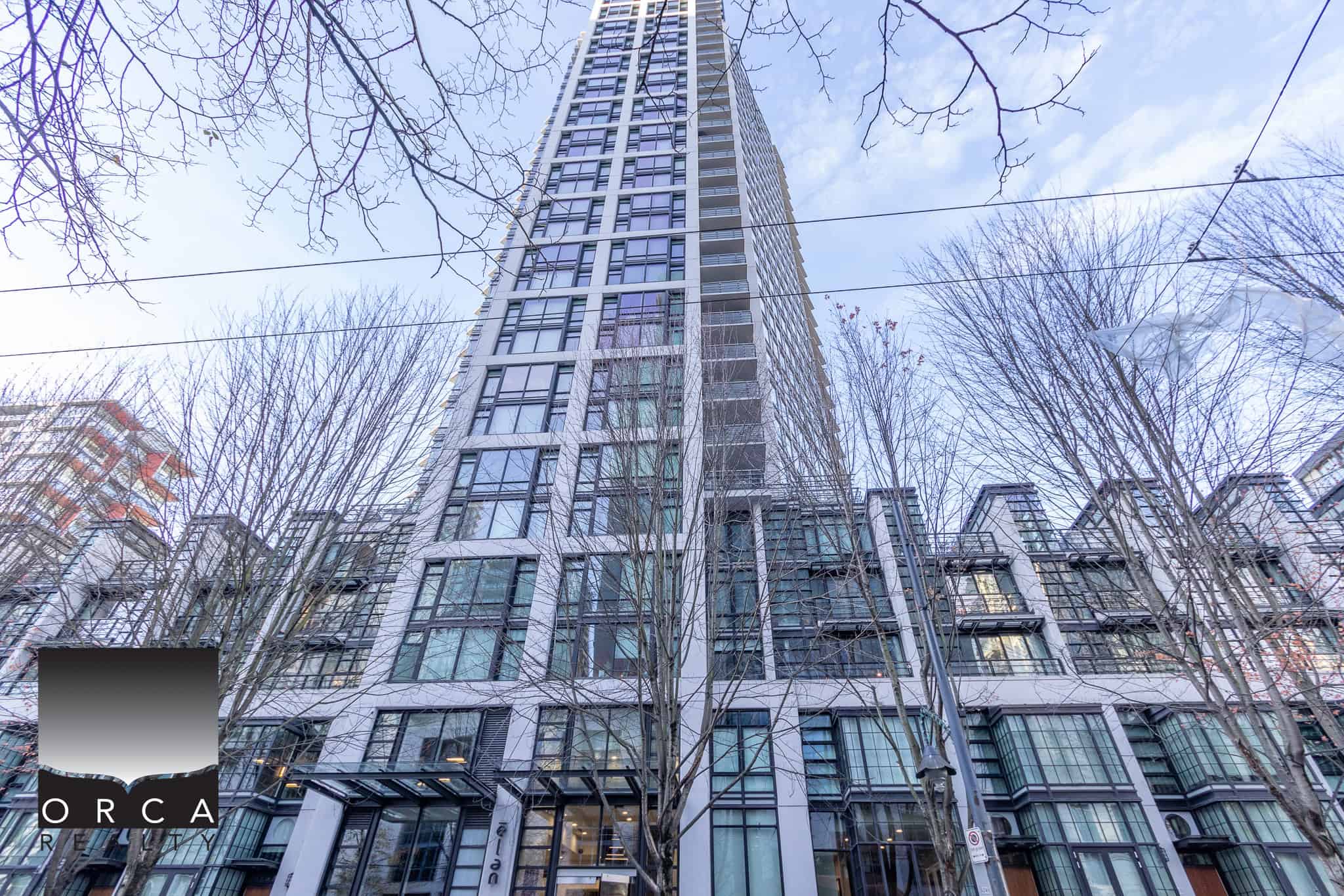 Modern high-rise condominium building in Vancouver, featuring sleek glass architecture and urban living amenities. Prime Vancouver real estate opportunity.