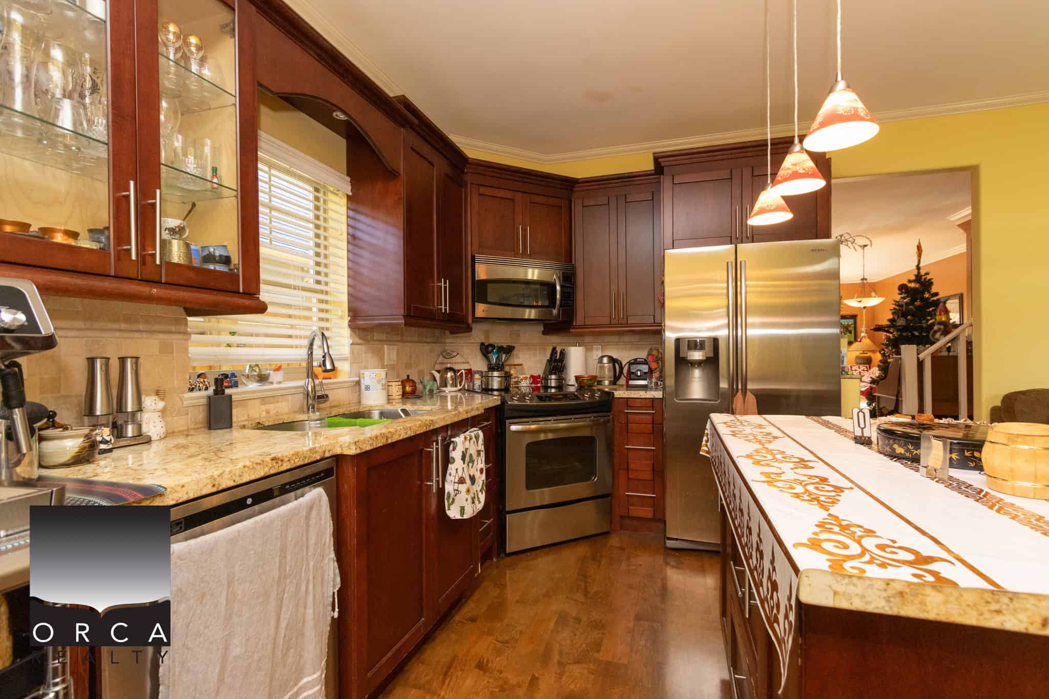 10 Bright kitchen with cherry wood cabinets and granite countertops, featuring stainless steel appliances, pendant lighting, and a cozy open-concept design perfect for family living and entertaining.